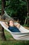 Young woman relaxing in the hammock in nature