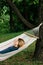 Young woman relaxing in the hammock in nature