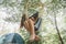 A young woman relaxing in a hammock in a wood