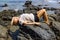 Young woman relaxing and meditating on picturesque rocky seashore