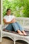 Young Woman Relaxing On Porch