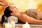 Young woman relaxing in spa at reiki session.