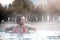 Young woman relaxing in thermal pool.