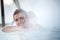 Young woman relaxing in thermal pool.