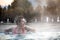 Young woman relaxing in thermal pool.