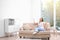 Young woman relaxing under air conditioner