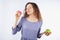 Young woman with relish eating a donut. Concept of harmful nutrition and diet