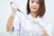 A young woman researcher, doctor, scientist, or laboratory assistant working with plastic medical tubes to research, examine