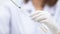 A young woman researcher, doctor, scientist, or laboratory assistant working with plastic medical tubes to research, examine