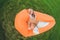 Young woman resting on an air sofa in the park.