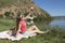 Young woman resting on bank of a the lake is