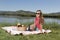 Young woman resting on bank of a the lake is