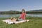 Young woman resting on bank of a the lake is