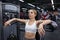 Young woman resting after exercises in modern gym