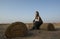 Young woman resting on an old carpet in a desert