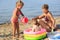 Young woman resting on the sea with children