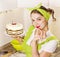 Young woman in retro clothes cooking sweet desert