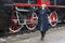 Young woman in retro styled clothes standing by vintage steam train