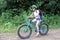 Young woman rides push up mountain bikes in Rarotonga Cook Islands