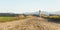 Young woman riding a bicycle on outdoor dusty road. Wide photo with space for text