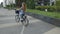 Young woman riding on bike in sunny day . Beautiful mood shot of young woman or girl riding bicycle in city. Girl with cerly hair