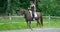 Young woman riding her arabian horse at farm