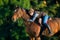 Young woman riding a horse.