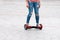 Young woman riding a hoverboard on the city square. New movement and transport technologies. Close up of dual wheel self