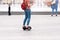 Young woman riding a hoverboard on the city square. New movement and transport technologies. Close up of dual wheel self