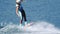 Young woman riding wakeboard on summer river. Entertainment on water of river