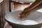 Young woman rinsing off bubble antibacterial soap from hands.