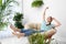 Young woman in room decorated with plants