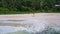 Young woman run on the sand paradise Anse Bazarca beach. With palm trees and foliage in background. Aerial 4k side