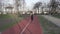 Young woman runner jogging on running track in the park. Activity, person. Runner running at running track. Keeping body