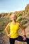 Young woman runner portrait on mountain trail