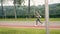 Young woman runner training in summer park. Sport and fitness training