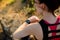 Young Woman Runner Using Multisport Smartwatch at Sunset Trail. Closeup of Hand with Fitness Tracker. Sports Concept