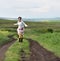 Young woman running on a countryside road. Freedom concept