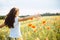 Young woman running through a field of wildflowers