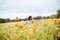 Young woman running through a field of wildflowers