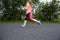 Young woman running outdoors on a lovely sunny winterl day