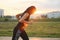 Young woman running at the stadium outdoor on the sunset