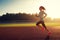 Young woman running on stadium track