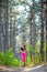 Young Woman Running on the Trail in the Beautiful Wild Pine Forest. Active Lifestyle Concept. Space for Text.