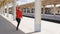 Young woman runs along platform catching up with train