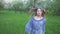 Young woman runs in an apple orchard in the spring flowers white. Portrait of a beautiful girl in the evening fruit