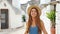 Young woman runs towards the camera in the old town of Alberobello in Italy