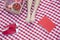 Young woman\'s feet on a checkered blanket with a picnic basket, shoes, and a book