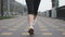 Young woman`s feet in white professional running sneakers doing intense training on city quay along river. Sports woman athlete ru