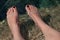Young woman\'s manicured feet in water